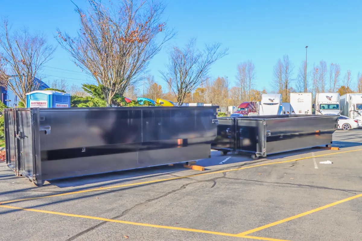 Professional dumpster rental service with roll-off container on residential driveway in Cramerton